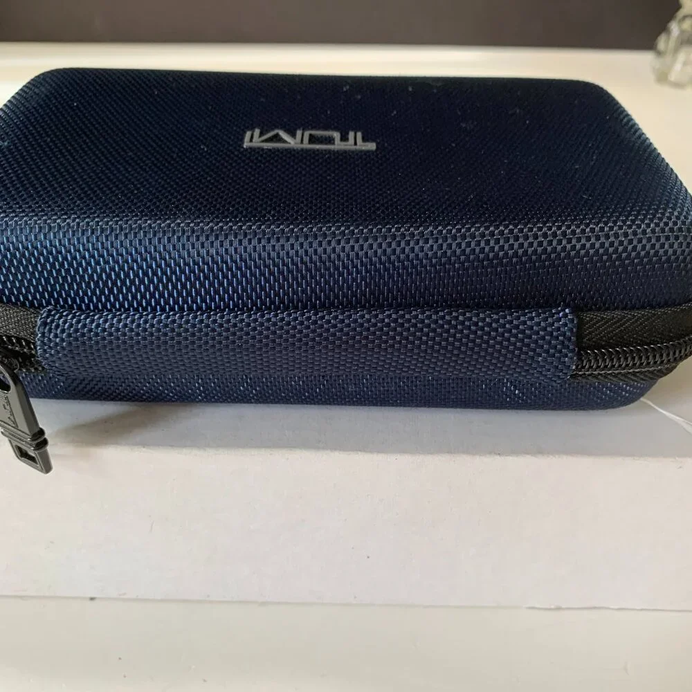 The product is a navy blue hard case amenity kit bag by TUMI for Delta Airlines.